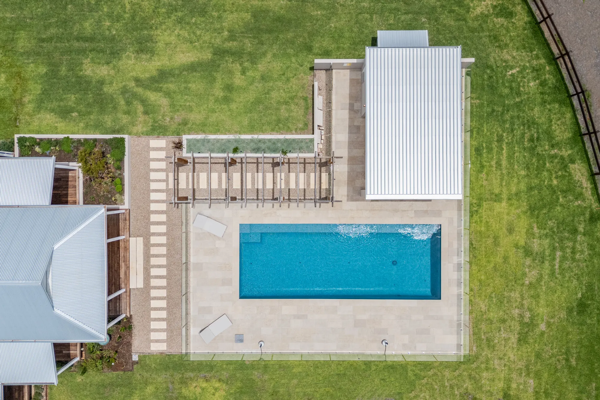 The pool, deck and paving seen straight down from above