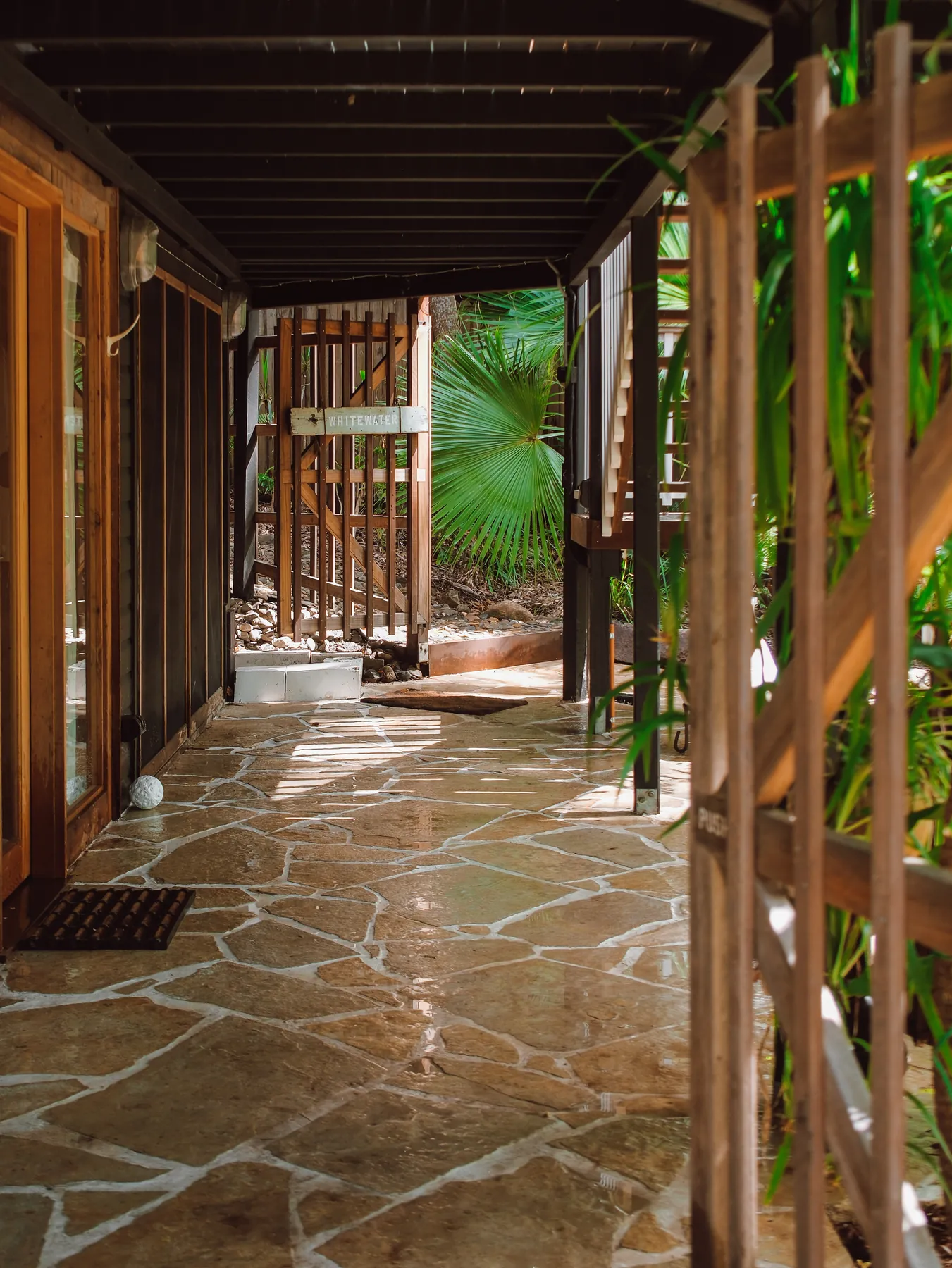 Sandstone crazy paving terraced beneath a rainforest home